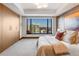 Bright bedroom with a large window showcasing a city view and neutral, modern design at 1133 14Th St # 3320, Denver, CO 80202