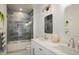 Modern bathroom featuring double sinks, stylish tile work, and a glass-enclosed shower at 2966 Casalon Cir, Superior, CO 80027