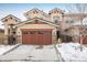 Charming two-story home featuring a spacious brown garage door, stucco siding, and stone accents at 2966 Casalon Cir, Superior, CO 80027