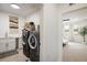 Well-organized laundry room with modern washer and dryer, counter space, and shelving at 2966 Casalon Cir, Superior, CO 80027