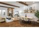 Bright living room and dining room with stone fireplace, wood beams, and modern furnishings at 2966 Casalon Cir, Superior, CO 80027