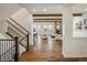 Open-concept living room featuring a beautiful stone fireplace, wood beams and hardwood floors at 2966 Casalon Cir, Superior, CO 80027