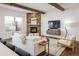 Bright living room featuring a stone fireplace, wood beams, and stylish furniture at 2966 Casalon Cir, Superior, CO 80027