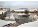 Neighborhood street view shows townhomes covered in snow with mountains in the background at 2966 Casalon Cir, Superior, CO 80027