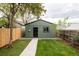 Green backyard with a concrete walkway and a small shed at 940 N Ogden, Denver, CO 80218