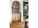Elegant bar area with checkered tile backsplash and wooden cabinets adds a touch of sophistication at 940 N Ogden, Denver, CO 80218