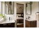 Stylish bathroom with dual sinks, modern mirrors, and view into the bedroom at 940 N Ogden, Denver, CO 80218