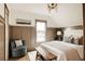 Comfortable bedroom with paneled walls, chair, and inviting natural light creates a serene atmosphere at 940 N Ogden, Denver, CO 80218