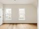 Bright bedroom with two large windows and hardwood floors provides ample natural light at 940 N Ogden, Denver, CO 80218