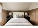Bedroom with large cushioned headboard, paneled walls, and neutral tones offers comfort and style at 940 N Ogden, Denver, CO 80218