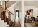Inviting foyer featuring hardwood floors, a staircase with decorative runners, and access to a modern kitchen at 940 N Ogden, Denver, CO 80218