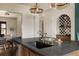 Kitchen island with a dark countertop, sink, and stylish pendant lighting. Modern kitchen at 940 N Ogden, Denver, CO 80218
