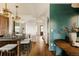 Spacious kitchen island with counter seating, stylish pendants, and hardwood floors for entertaining at 940 N Ogden, Denver, CO 80218