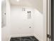 Clean laundry room with dark marble floors and white walls at 940 N Ogden, Denver, CO 80218