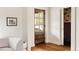 Bright living area showcasing hardwood floors, a decorative door, and a peek into a unique powder room at 940 N Ogden, Denver, CO 80218