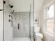Modern bathroom with glass-enclosed shower featuring sleek fixtures and elegant tile at 940 N Ogden, Denver, CO 80218