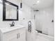 Modern bathroom with white marble tiles, a glass-enclosed shower, and a vanity with a sink at 800 N Pearl St # 1203, Denver, CO 80203