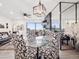 Bright dining room boasts a glass table, patterned chairs, and city views through expansive windows at 800 N Pearl St # 1203, Denver, CO 80203
