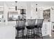 Bright kitchen features white cabinets, quartz countertops, stainless steel appliances, and breakfast bar at 800 N Pearl St # 1203, Denver, CO 80203