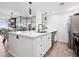 Modern kitchen with stainless steel appliances, white cabinetry, and a large island with a sink at 800 N Pearl St # 1203, Denver, CO 80203
