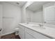 Bathroom featuring double vanity sinks, white cabinets, a large mirror, and a separate shower/tub space at 10065 Quari Ct, Commerce City, CO 80022