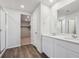 Bathroom featuring double sink vanity, mirror, and walk-in shower at 10065 Quari Ct, Commerce City, CO 80022