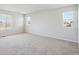 Spacious bedroom with neutral carpet, large windows, and natural light at 10065 Quari Ct, Commerce City, CO 80022