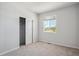 Bright, carpeted bedroom with a closet and a large window offering natural light at 10065 Quari Ct, Commerce City, CO 80022