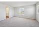 Bright bedroom with neutral carpet and a bathroom attached at 10065 Quari Ct, Commerce City, CO 80022
