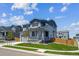 Inviting two-story home featuring a manicured lawn and cozy front porch at 10065 Quari Ct, Commerce City, CO 80022