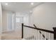 Hallway with carpet and staircase with white railing at 10065 Quari Ct, Commerce City, CO 80022