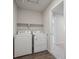 Laundry room featuring side-by-side white washer and dryer at 10065 Quari Ct, Commerce City, CO 80022