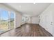 Spacious living room boasts hardwood floors, recessed lighting, and a sliding glass door at 10065 Quari Ct, Commerce City, CO 80022