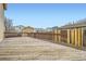 A spacious wooden back deck overlooking neighboring homes and backyards, creating a cozy outdoor space at 1946 Ensenada St, Aurora, CO 80011
