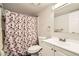 Bathroom with a cherry-themed shower curtain and standard fixtures at 1946 Ensenada St, Aurora, CO 80011