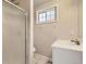 Tiled bathroom featuring a shower and white vanity at 1946 Ensenada St, Aurora, CO 80011