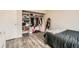 Bedroom featuring hardwood flooring, closet, and mirror at 1946 Ensenada St, Aurora, CO 80011