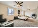 Spacious bedroom featuring carpeted floors, two windows, and ceiling fans at 1946 Ensenada St, Aurora, CO 80011