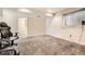 A carpeted bedroom with a window and a large comfortable chair, perfect for relaxing or working at 1946 Ensenada St, Aurora, CO 80011
