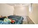 A bedroom with carpet and a small window to let in natural light, and some personal items on the bed at 1946 Ensenada St, Aurora, CO 80011