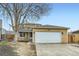 Charming two-story home with a two-car garage and a mature tree in the front yard at 1946 Ensenada St, Aurora, CO 80011