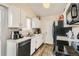 Clean and bright kitchen with stainless steel appliances, white cabinets, and laminate countertops at 1946 Ensenada St, Aurora, CO 80011