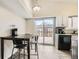 A bright dining space and kitchen combo featuring matching appliances and deck access at 1946 Ensenada St, Aurora, CO 80011