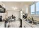 Kitchen with stainless appliances, eat-in counter, open floor plan, and sliding door to the outside at 1946 Ensenada St, Aurora, CO 80011