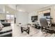 Open-concept living area with wood-look floors, lots of light, and easy access to dining and kitchen at 1946 Ensenada St, Aurora, CO 80011