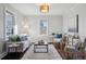 Bright living room with hardwood floors and comfy seating at 1305 Tamarac St, Denver, CO 80220