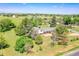 Aerial view of charming home with an expansive lot, mature trees, and mountain views at 15065 Huron St, Broomfield, CO 80023