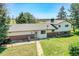 Aerial view of house and expansive backyard with mature trees and ample green space at 15065 Huron St, Broomfield, CO 80023