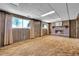 Basement with a brick fireplace and wooden-paneled walls at 15065 Huron St, Broomfield, CO 80023
