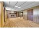 Finished basement with wood-paneled walls, brick fireplace, and neutral-toned carpeting at 15065 Huron St, Broomfield, CO 80023